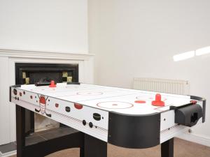 a ping pong table in front of a fireplace at 4 Bed in Skegness oc-81343 in Wainfleet All Saints
