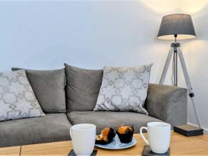 a living room with a couch and a table with two cups at 4 Bed in Skegness oc-81343 in Wainfleet All Saints +5 photos
