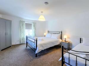 a bedroom with two beds and a window at 4 Bed in Skegness oc-81343 in Wainfleet All Saints