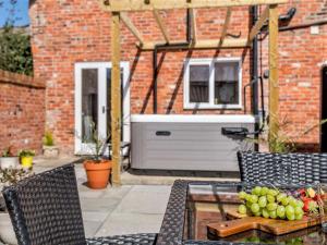 a table with a bowl of fruit on a patio at 4 Bed in Skegness oc-81343 in Wainfleet All Saints