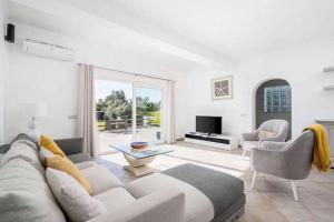 a living room with a couch and a table at Casa Jardim in Loulé