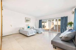 a large bedroom with two beds and a couch at Casa Jardim in Loulé +24 photos