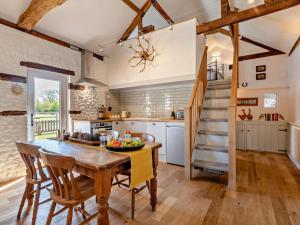 a kitchen with a table and chairs and a staircase at 1 Bed in Kings Lynn oc-32202 in Beeston +17 photos