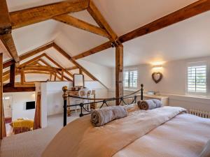 a large bed in a room with wooden beams at 1 Bed in Kings Lynn oc-32202 in Beeston