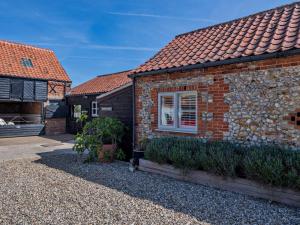 a brick house with a window and a brick roof at 1 Bed in Kings Lynn oc-32202 in Beeston