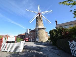 a windmill in front of a building with a white fence at 2 Bed in Boston oc-90123 in Boston +4 photos