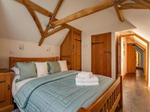 a bedroom with a large bed in a room with wooden ceilings at 2 Bed in Holt oc-ncc39 in Cley next the Sea
