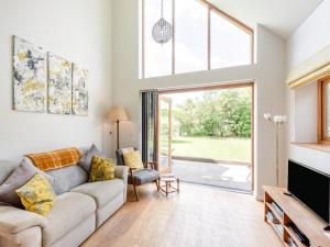 a living room with a couch and a large window at 1 Bed in Etchingham oc-78940 in Hawkhurst