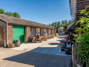 a row of brick buildings with tables and umbrellas at 1 Bed in Ashford oc-82527 in Biddenden