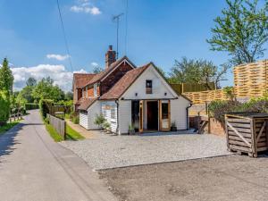 a small white house on a gravel driveway at 1 Bed in Ashford oc-82527 in Biddenden +9 photos