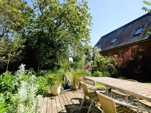 a wooden deck with a table and chairs and plants at 2 Bed in Alford oc-42581 in Ulceby