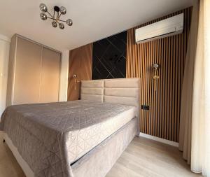 a bedroom with a bed and a chandelier at NOIR Luxury in Trebinje +42 photos