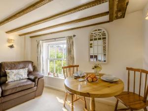 a living room with a table and a couch at 1 Bed in Battle oc-83845 in Sedlescombe