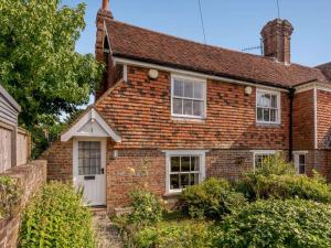 an old brick house with a white door at 1 Bed in Battle oc-83845 in Sedlescombe