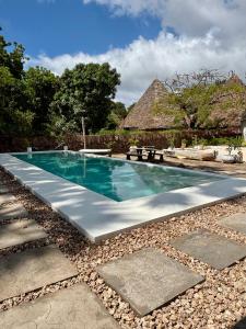 a swimming pool in the middle of a resort at Flower House in Malindi
