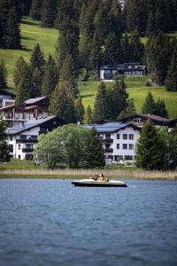 a group of people in a boat on a lake at Hotel Seehof direkt am Heidsee in Valbella