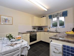 a kitchen with white cabinets and a counter top at 2 Bed in Colchester oc-42650 in Dedham