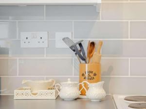 a kitchen counter with a container filled with utensils at 1 Bed in Broadstairs oc-89359 in Broadstairs +4 photos