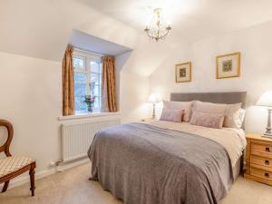a bedroom with a bed and a chair and a window at 3 Bed in Lincoln oc-90396 in Washingborough