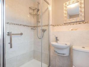 a bathroom with a shower and a toilet and a sink at 3 Bed in Lincoln oc-90396 in Washingborough +19 photos
