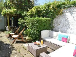 a garden with a white couch and a table at 3 Bed in Whitstable oc-84042 in Whitstable