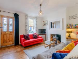 a living room with a red couch and a red chair at 3 Bed in Whitstable oc-84042 in Whitstable