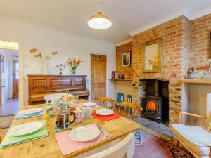 a living room with a table and a fireplace at 3 Bed in Whitstable oc-84042 in Whitstable +9 photos