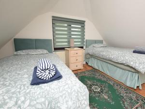 a bedroom with two beds and a dresser and a window at 2 Bed in Hailsham oc-89416 in Hailsham
