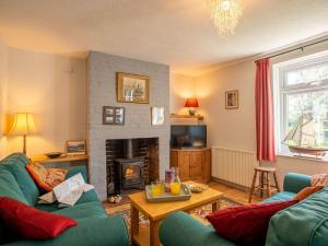 a living room with two couches and a fireplace at 2 Bed in Lowestoft oc-88109 in Lowestoft