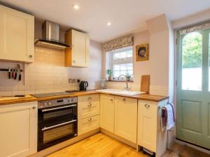 a kitchen with white cabinets and a stove top oven at 2 Bed in Lowestoft oc-88109 in Lowestoft