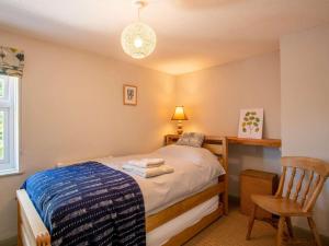 a bedroom with a bed and a desk and a chair at 2 Bed in Lowestoft oc-88109 in Lowestoft