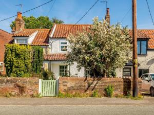 a house with a brick fence and a tree at 2 Bed in Lowestoft oc-88109 in Lowestoft +6 photos