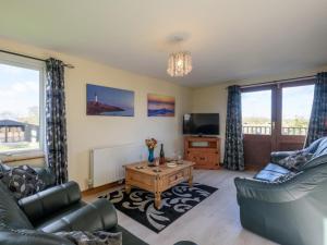 a living room with two couches and a tv at 3 Bed in Dereham oc-65903 in Foulsham