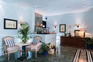 a lobby with a table and chairs and a counter at Areela Boutique Hotel in Tirana