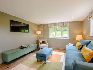 a living room with a blue couch and a table at 1 Bed in Battle oc-88029 in Brightling +7 photos