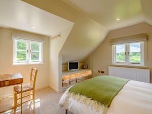 a bedroom with a bed and a desk and windows at 1 Bed in Battle oc-88029 in Brightling