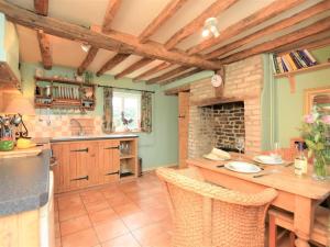 a kitchen with a wooden table and a fireplace at 2 Bed in Bedford oc-62322 in Wyboston +13 photos