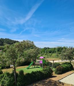 a park with a playground and a swing at Flower Camping de L Olivigne in Bize-Minervois