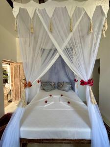 a bedroom with a bed with a canopy at Flower House in Malindi +104 photos