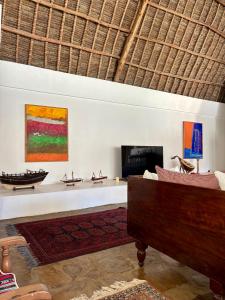 a living room with a couch and a fireplace at Flower House in Malindi