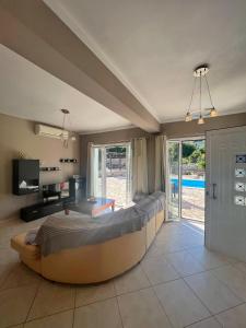 a bedroom with a large bed and a sliding glass door at Villa Melissani in Karavomylos