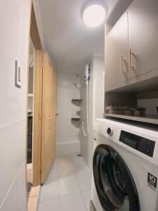 a washer and dryer in a white laundry room at AJA Suite in Davao City