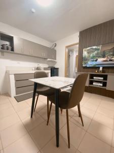 a kitchen with a table and chairs in a room at AJA Suite in Davao City