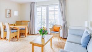 a living room with a couch and a table at Hapimag Resort Dünenblick in Westerland