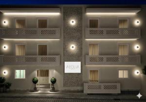 a building with a sign on the side of it at Aeolia suites in Karpathos