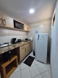 a kitchen with a refrigerator and a counter top at NATAL PLAZA PONTA NEGRA in Natal +25 photos