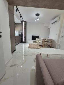 a living room with a table and a kitchen at Апартамент Top Central in Yambol