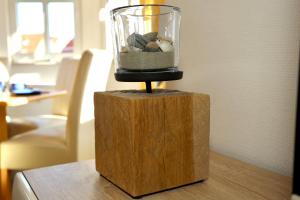 a glass jar filled with rocks on top of a wooden table at Turmwohnung 205 in Juist +41 photos