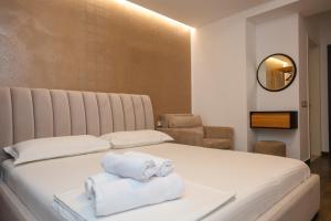 a bedroom with a bed with towels on it at Hotel Adria 2 Shengjin in Shëngjin