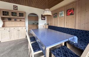 a kitchen with a blue table and wooden cabinets at Chalet Villa Josi Superior Appartement 12 in Leutasch